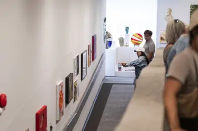 People looking at art on walls