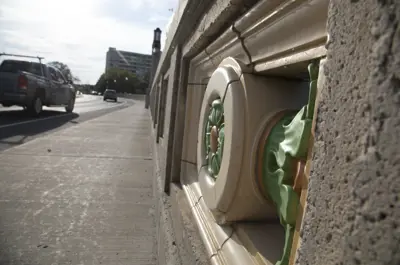 Bridge with decorative feature on wall
