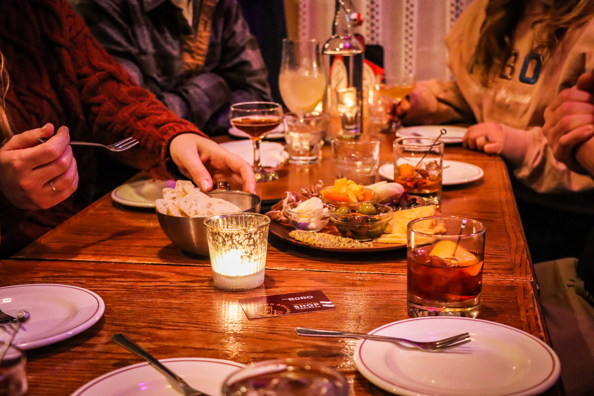 People gathered around a candlelit meal