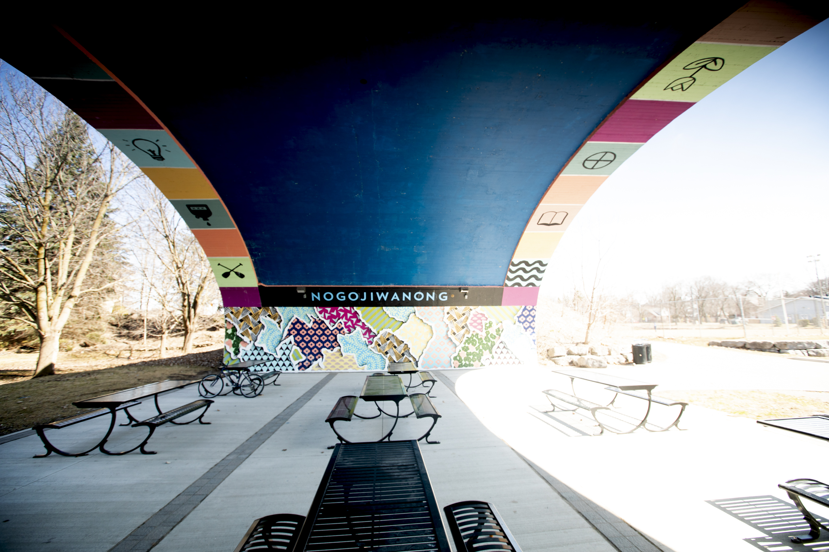 Painting under the arch of a bridge with blocks of colours and symbols