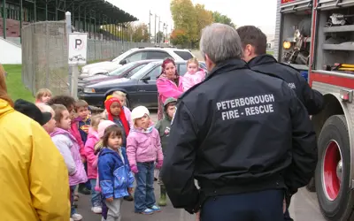 Fire rescue talking to group of young students