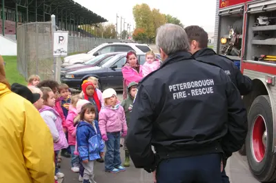 Fire rescue talking to group of young students