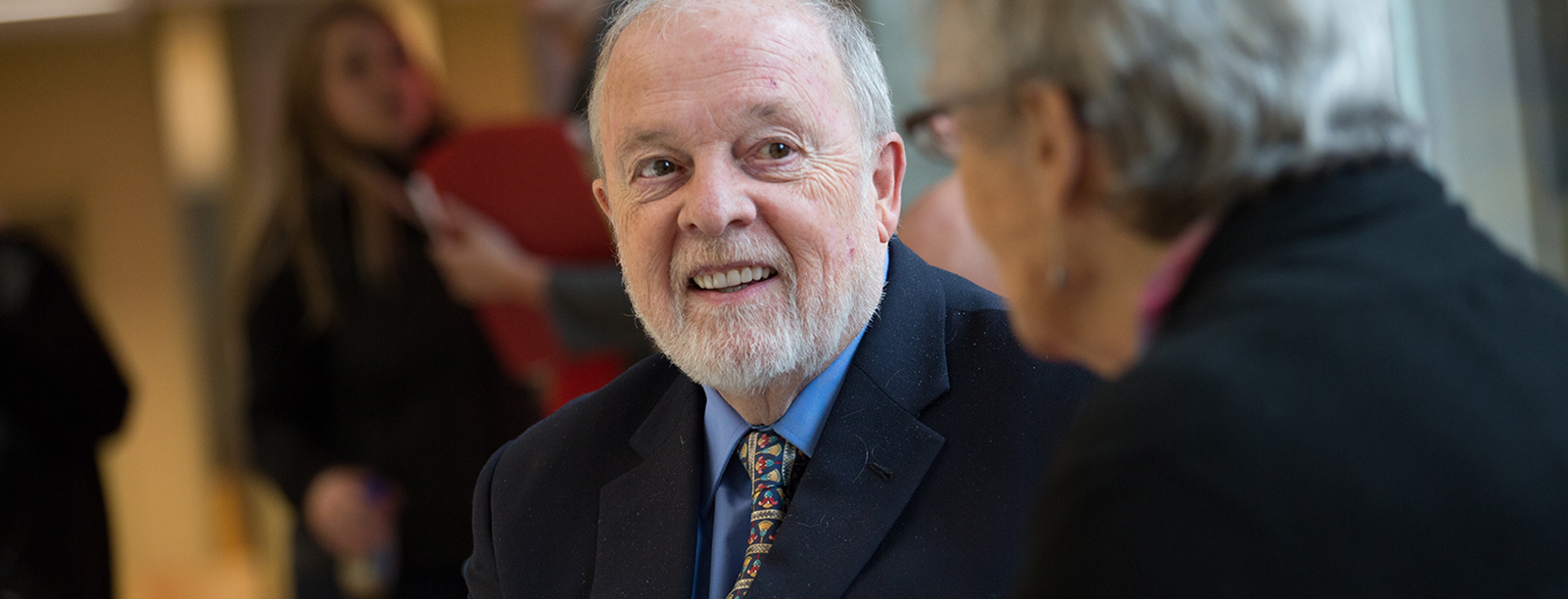 Two older adults speaking to each other