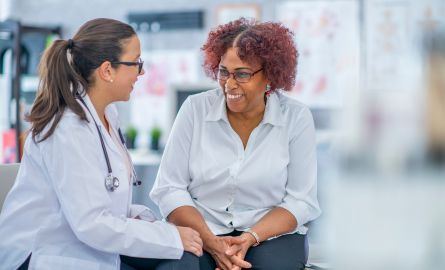 A medical practitioner in conversation with a patient