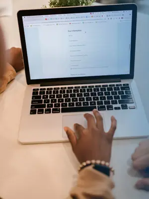A person is filling out a form on a computer