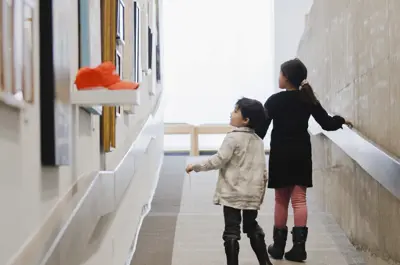Children looking at art on wall in Art Gallery