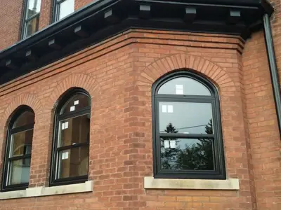 Exterior of a red brick house, tall windows