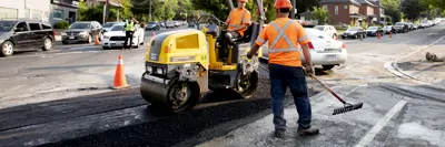 Road construction crew with two workers 