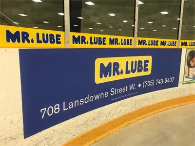 Rink board and wrapping with Mr. Lube sponsorship advertising on it.