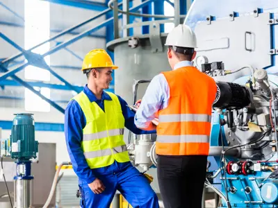 Two workers discuss a machine in a high tech factory