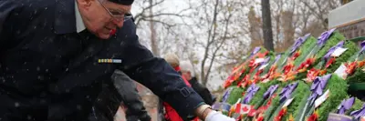 a veteran lays down a wreath at the Citizens War Memorial during Remembrance Day service