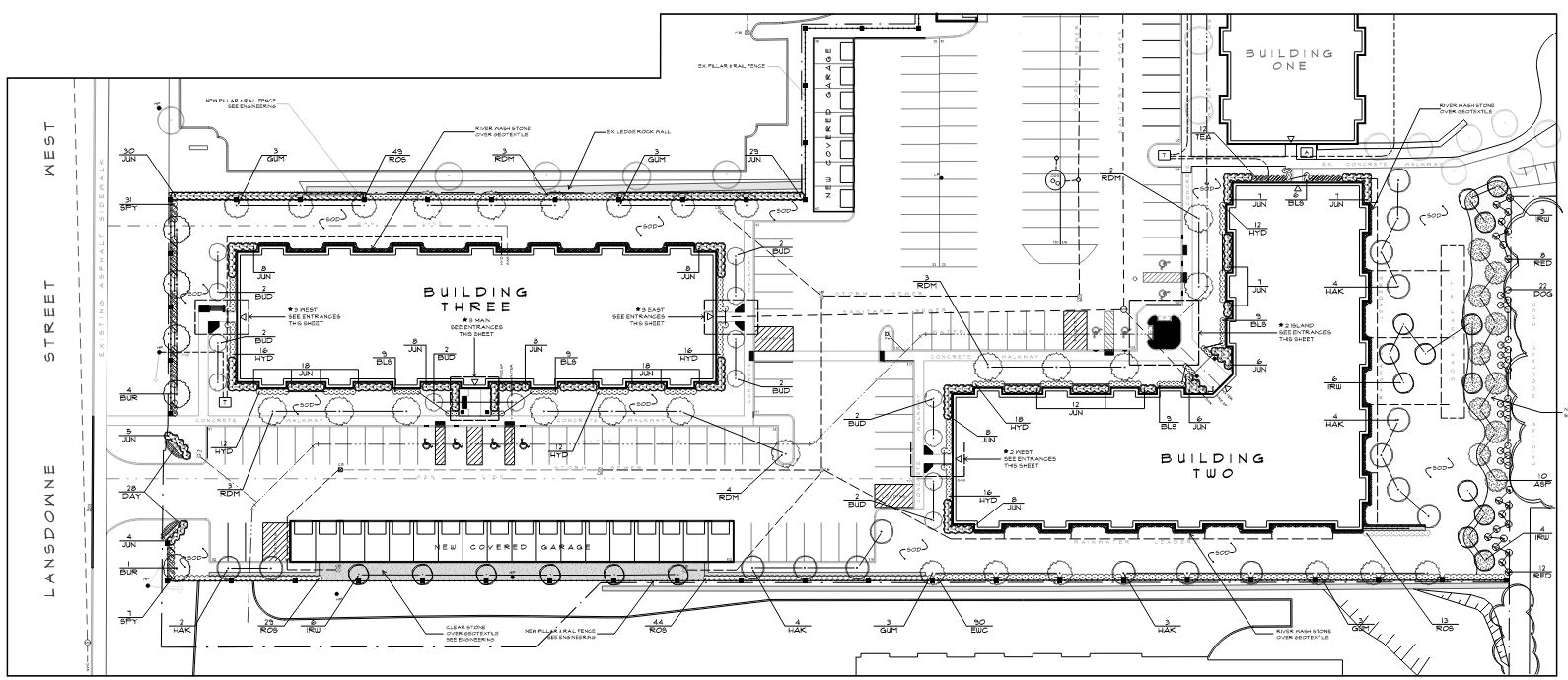 Site Plan drawing with two buildings, parking area, landscaping elements and covered garage