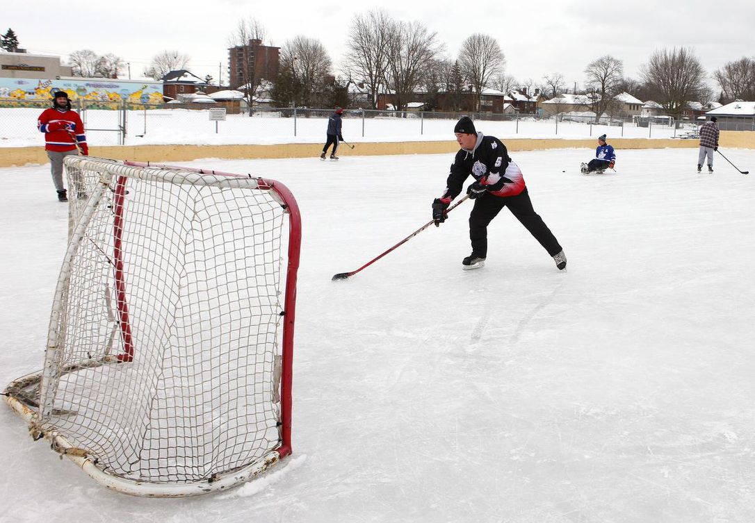 Man playing hockey at an outdoor rink