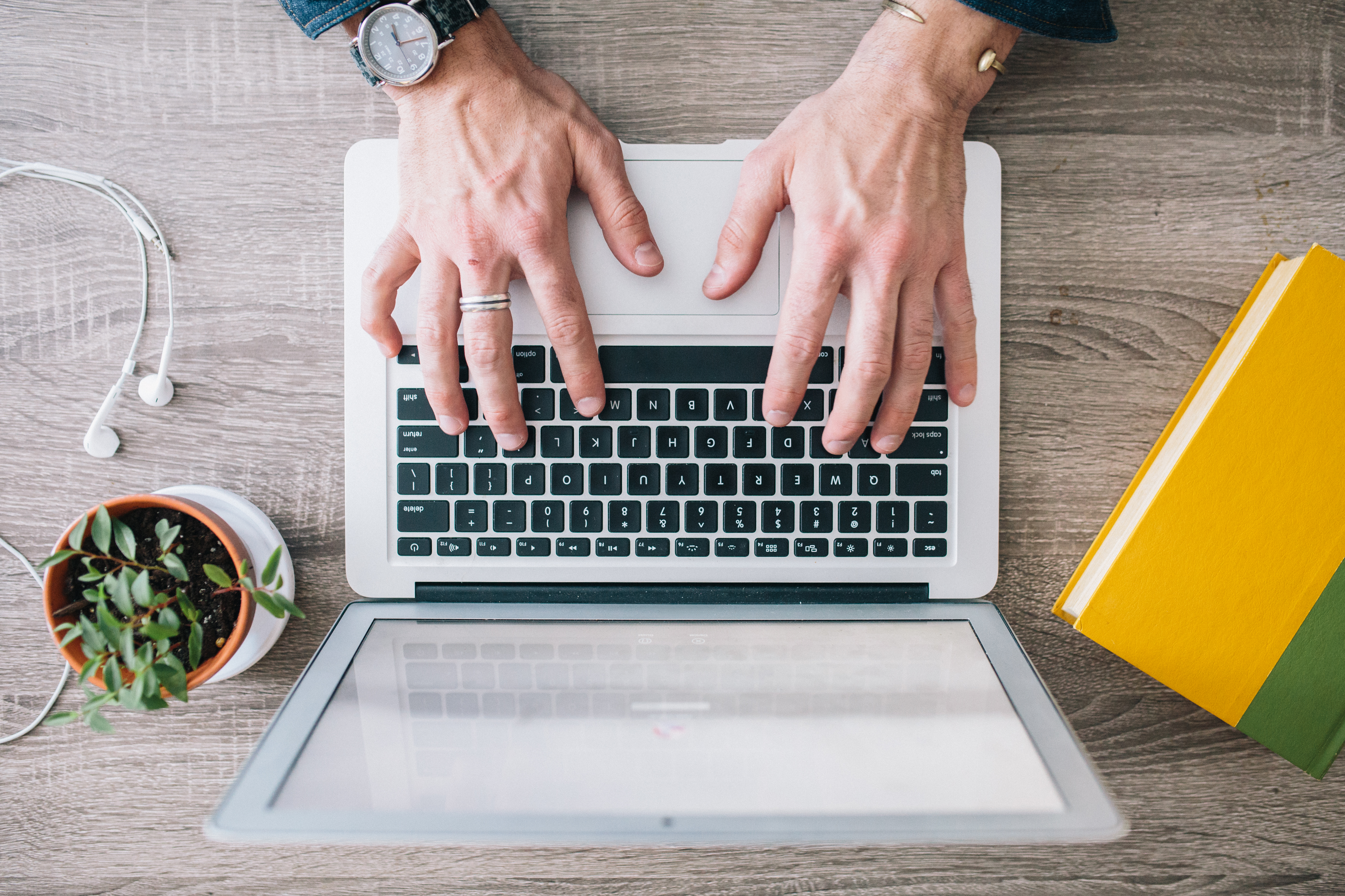 overview angle of a person typing on a laptop