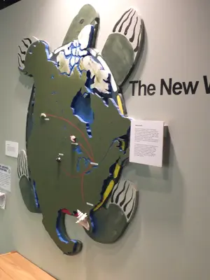 Museum exhibit with wall mounted Turtle Island feature and digital screen
