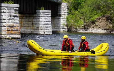 Two firefighters in boat on river