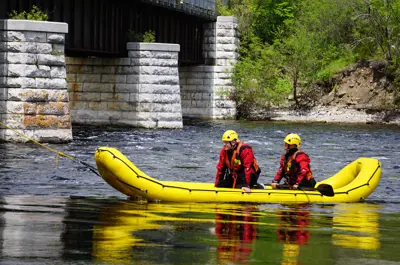 Two firefighters in boat on river