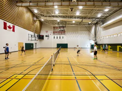 People playing pickleball in the Sport and Wellness centre gym