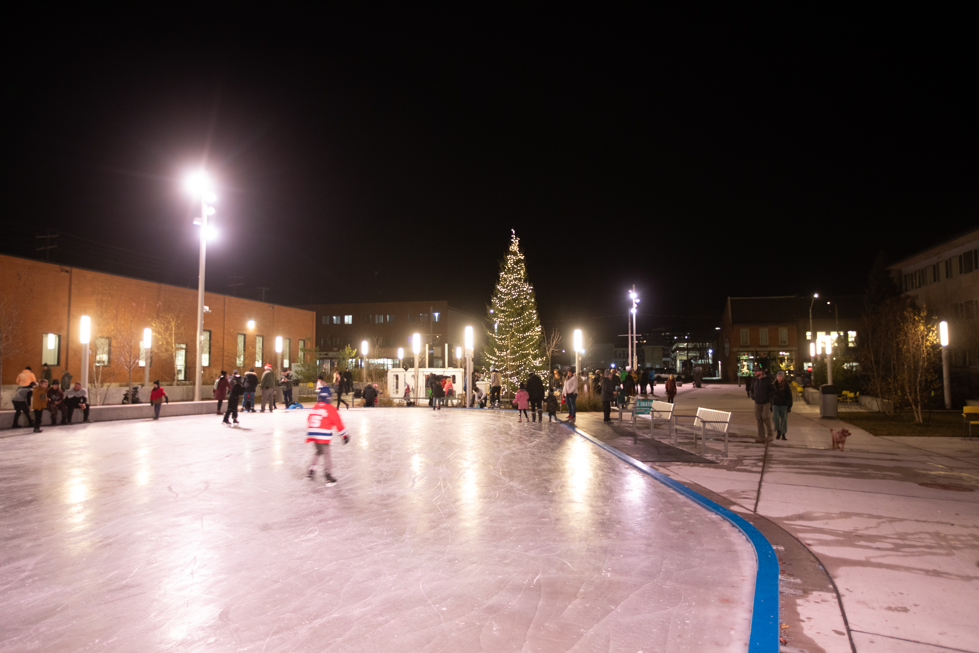 Skating on Quaker Square outdoor rink at night